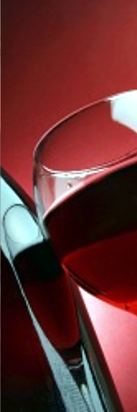 A bottle of red wine and a half full glass of wine.